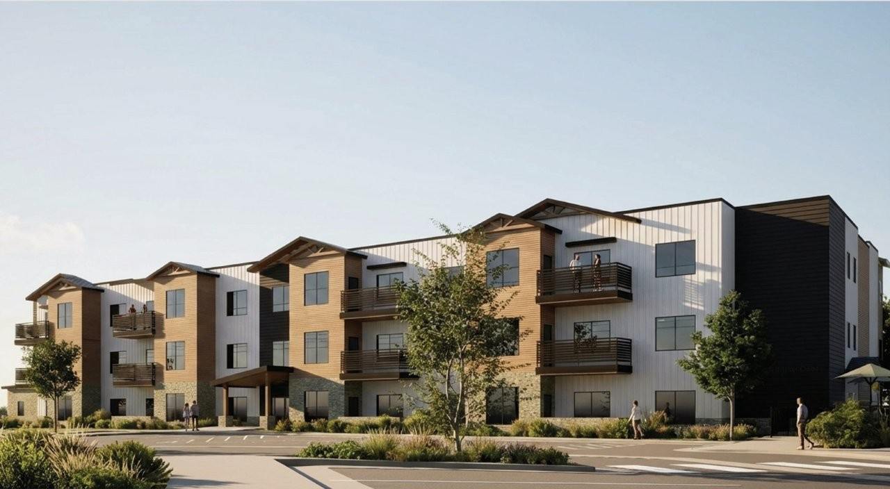 A modern apartment complex with multiple balconies and a courtyard.